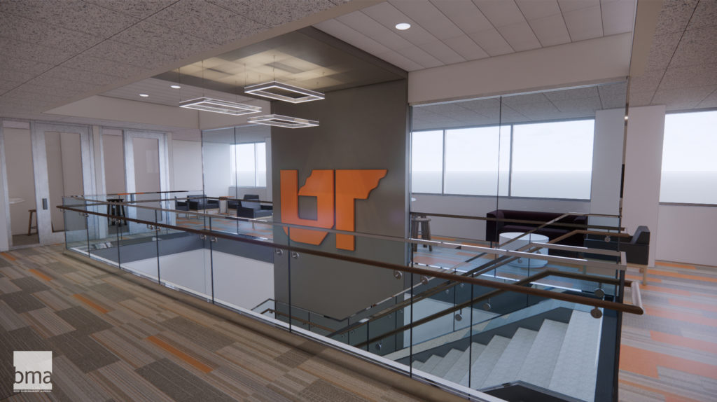 A stairwell opens up to a lobby area with a large UT icon sign